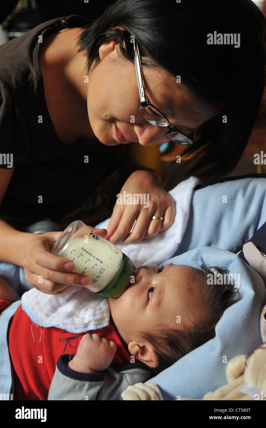 INFANT DRINKING FROM BABY BOTTLE Stock Photo Alamy