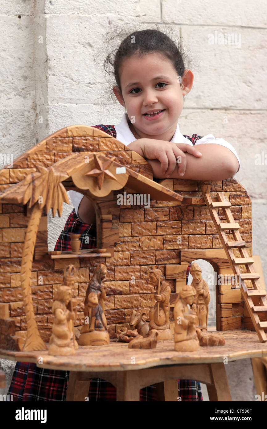 Girl with nativity crib at a souvenir shop close to the the Church of the Nativity, Bethlehem, Palestine Stock Photo