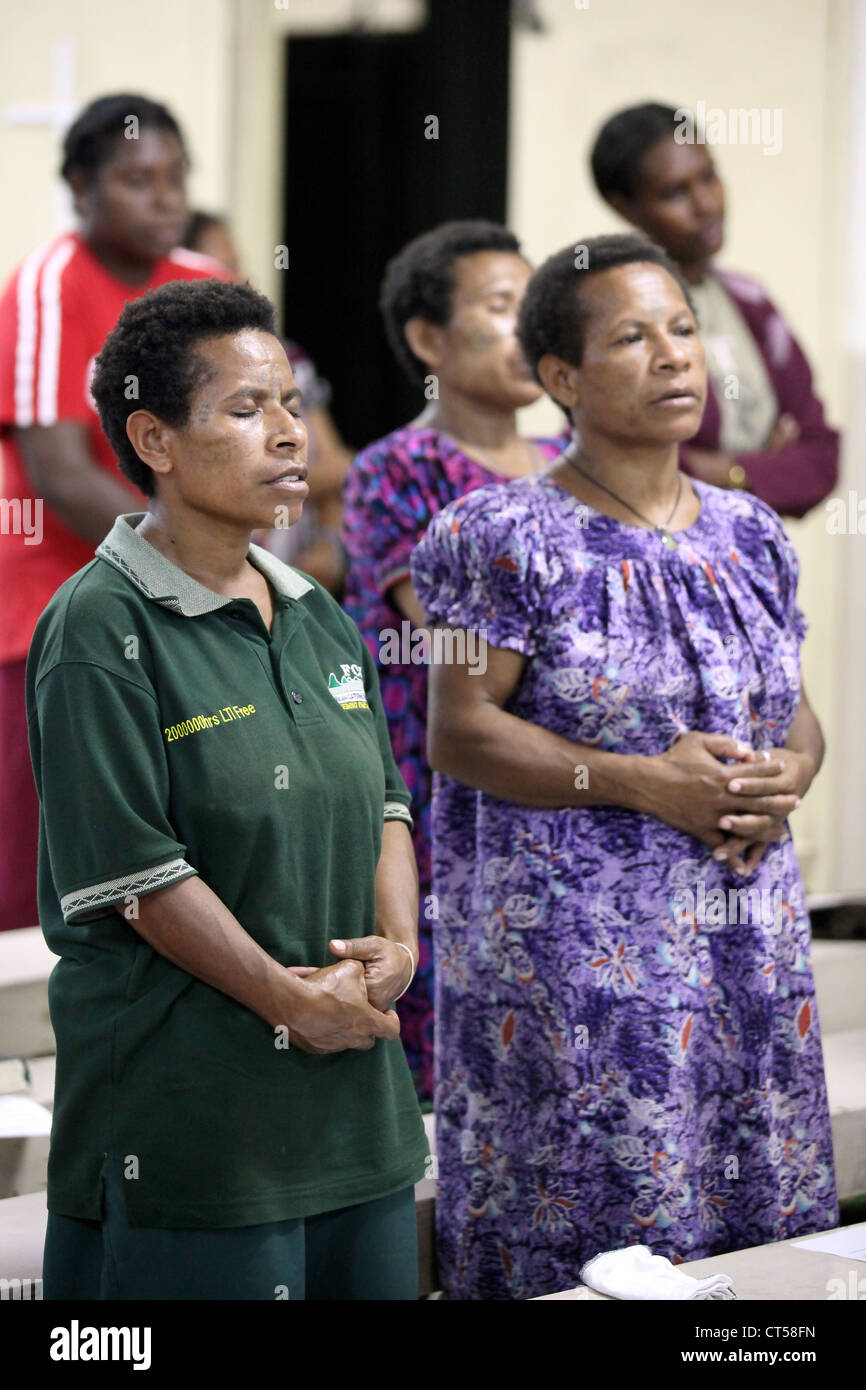 woman at the holy Sunday mass in the catholic church ' Our Lady of the star Mountain ' in Tabubil, Papua New Guinea Stock Photo