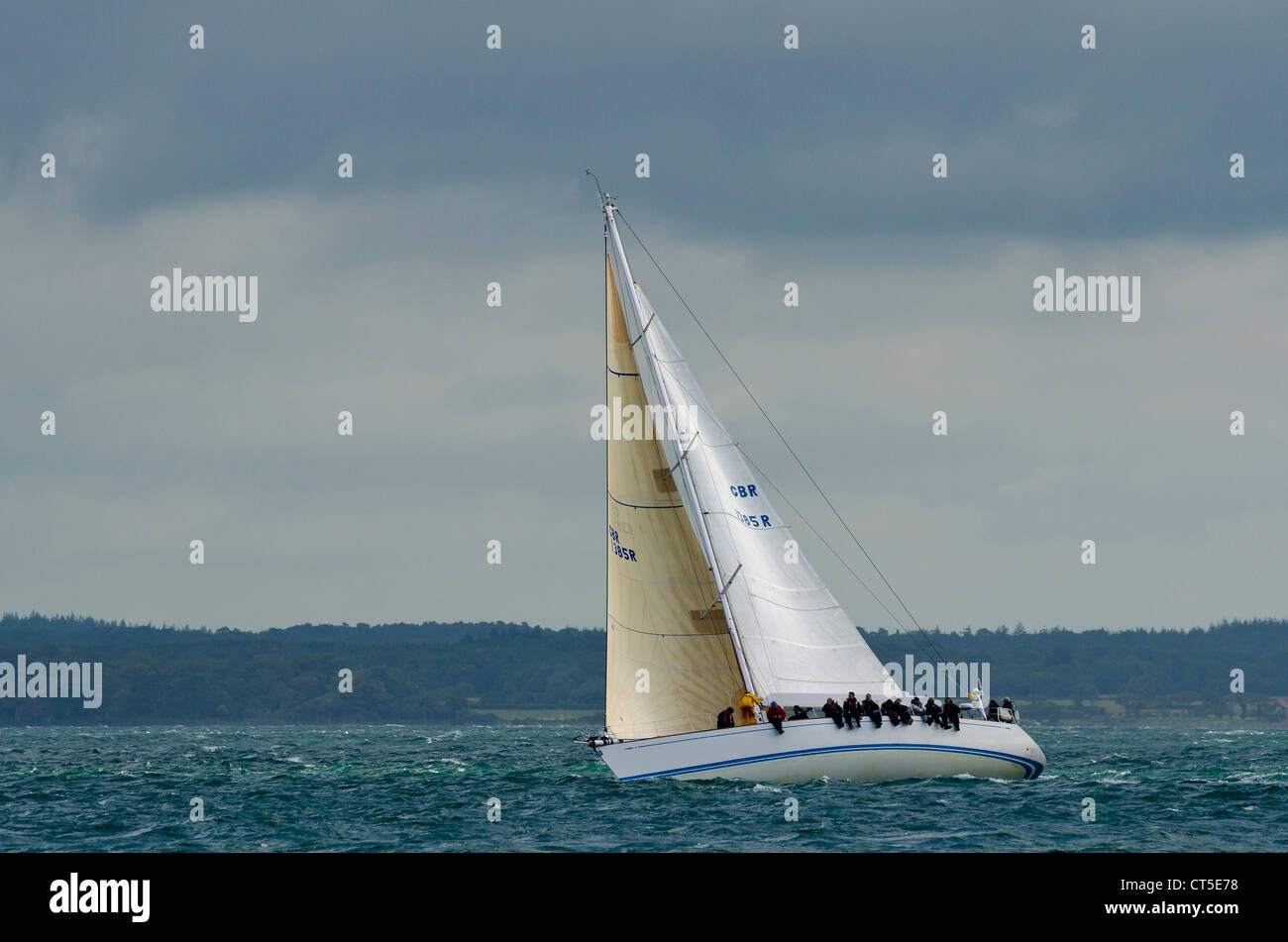 Race yacht off Yarmouth in the Solent during the 2012 Round The Island Race Stock Photo
