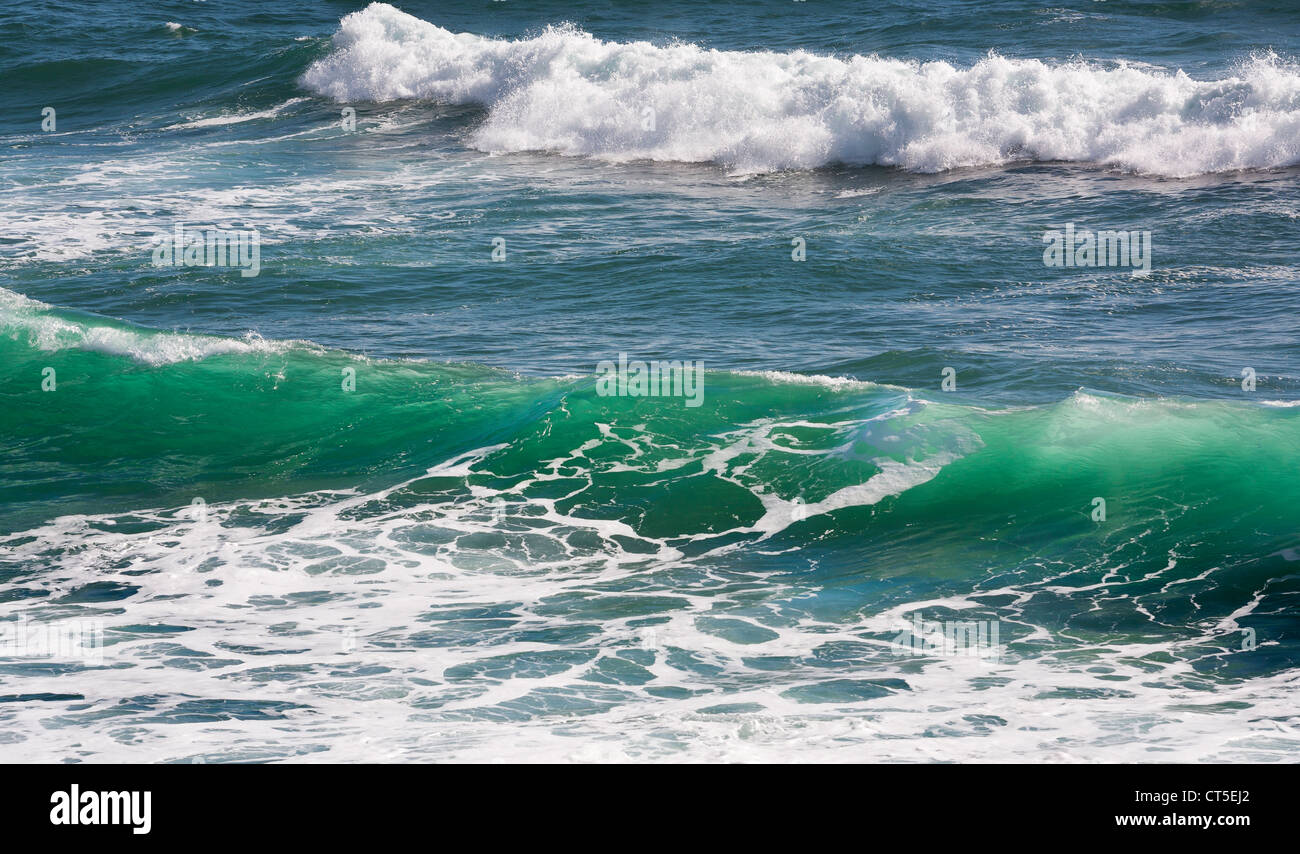 Breaking sea waves, backlit with an aquamarine colour Stock Photo
