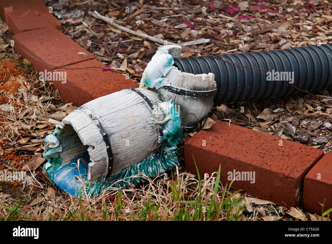 Whimsical downspout extender is not only decorative, but is functional as well. Stock Photo