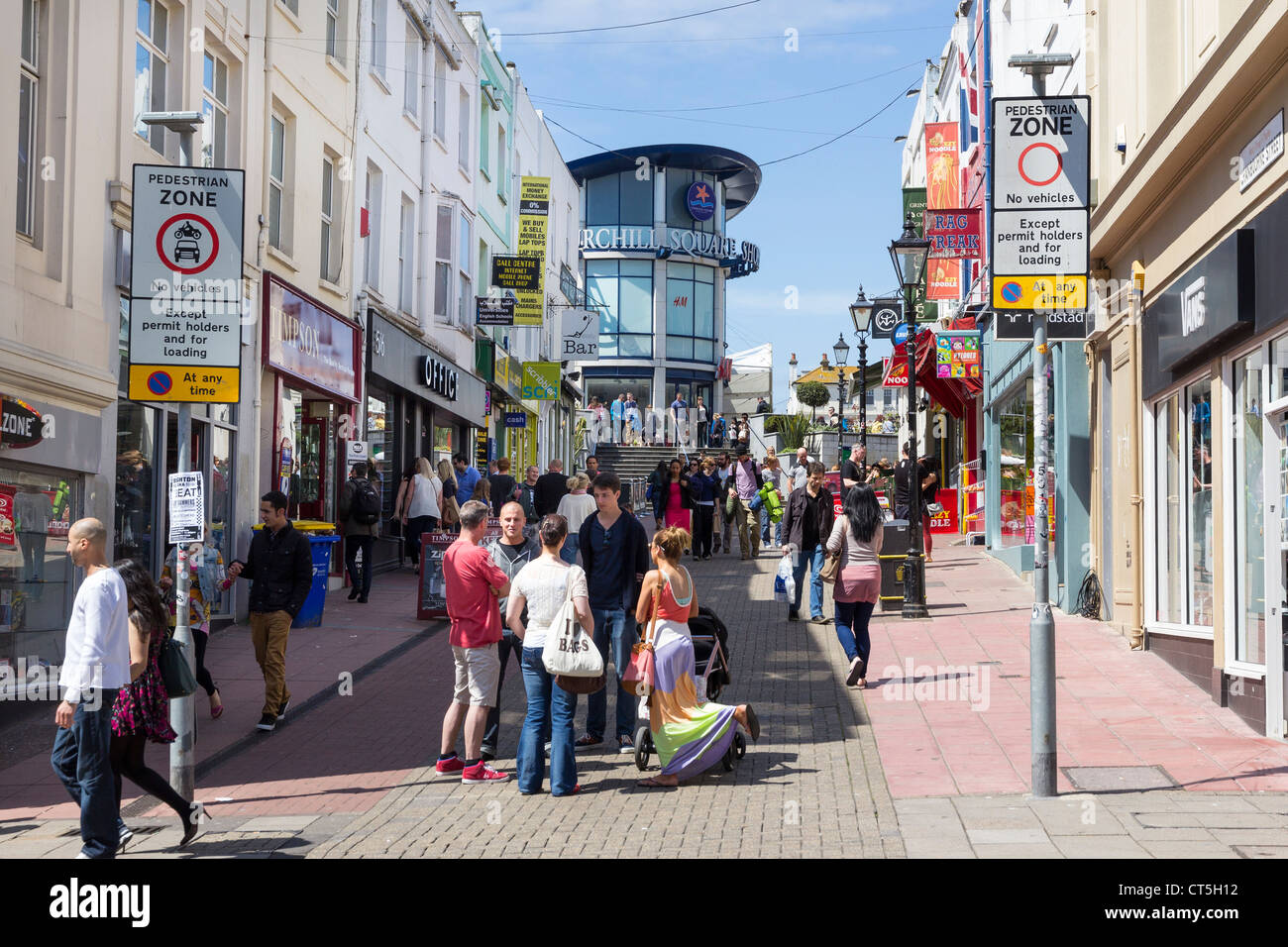 A busy pedestrianised shopping street in Brighton, Sussex leading to the Churchill Square shopping centre Stock Photo