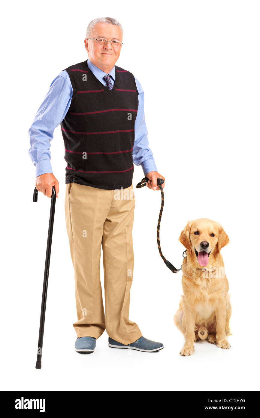 Full length portrait of a senior man holding a cane and a dog isolated