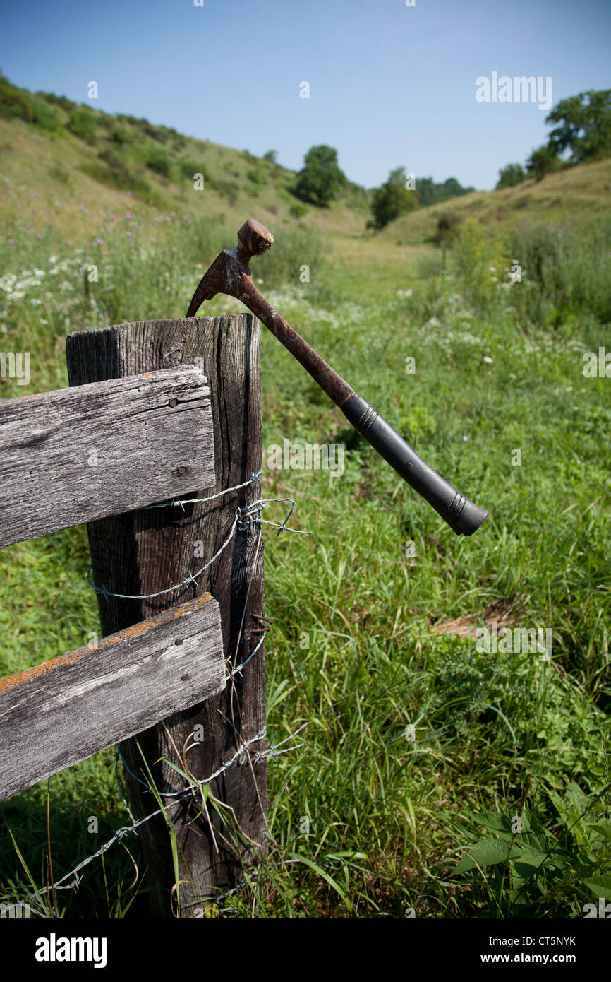 Hammer used to put up new barbed wire fence on the farm Stock Photo Alamy