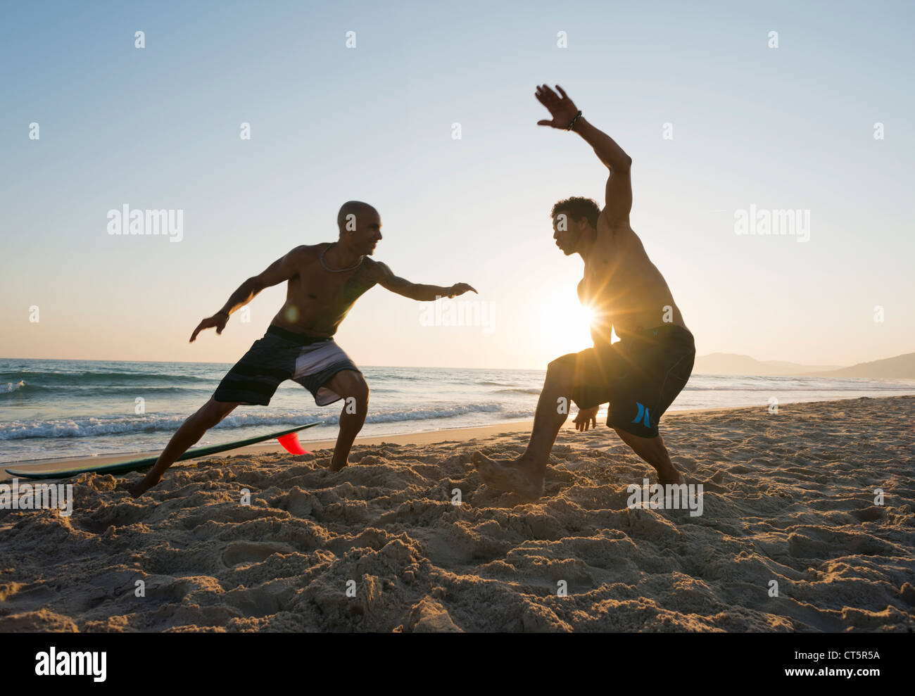 Men playing at the beach. Stock Photo