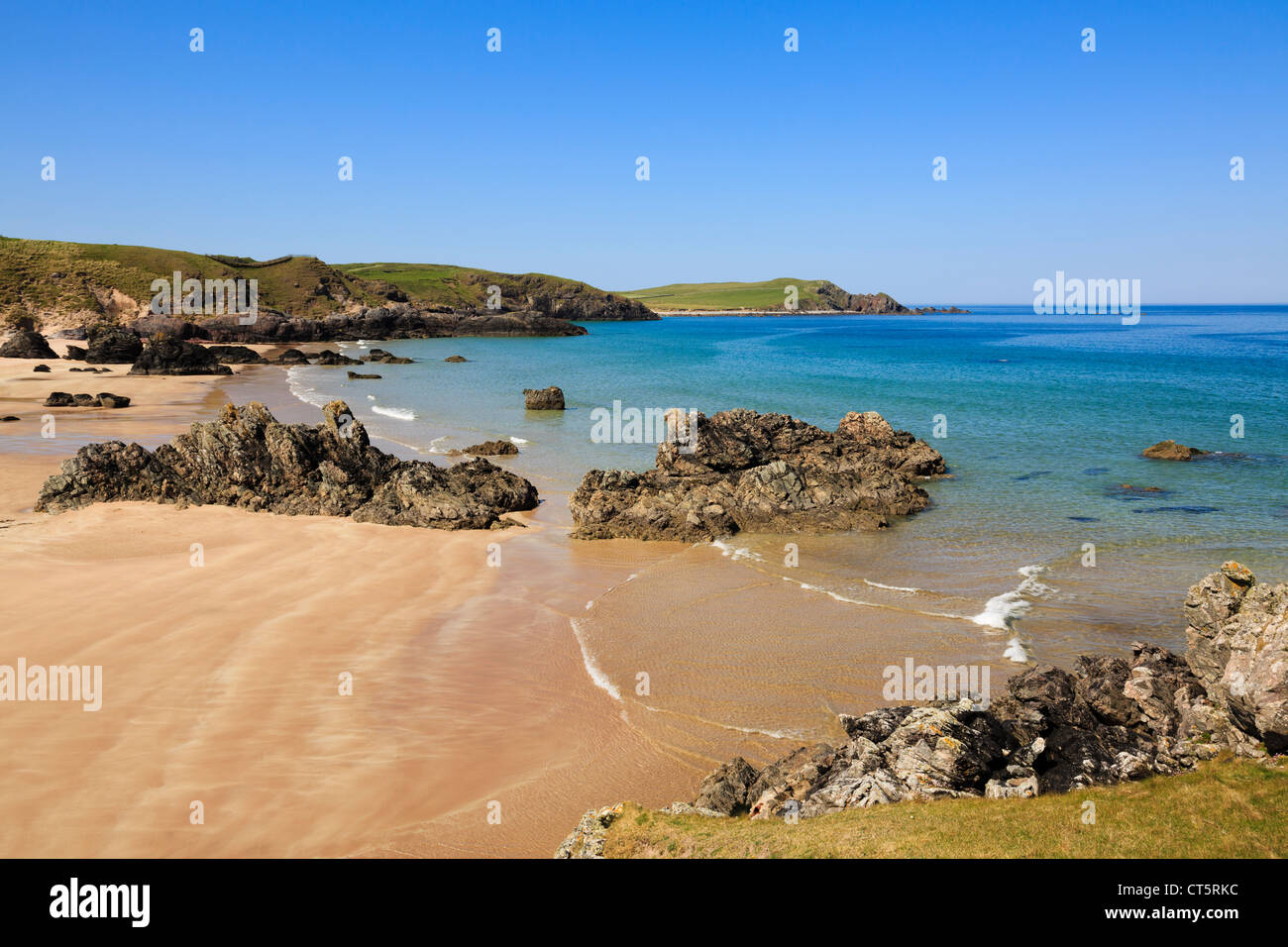 Rocks on beach of stunning golden sands and turquoise sea on Scottish North Coast 500 route. Sango Bay Durness Sutherland Highland Scotland UK Stock Photo