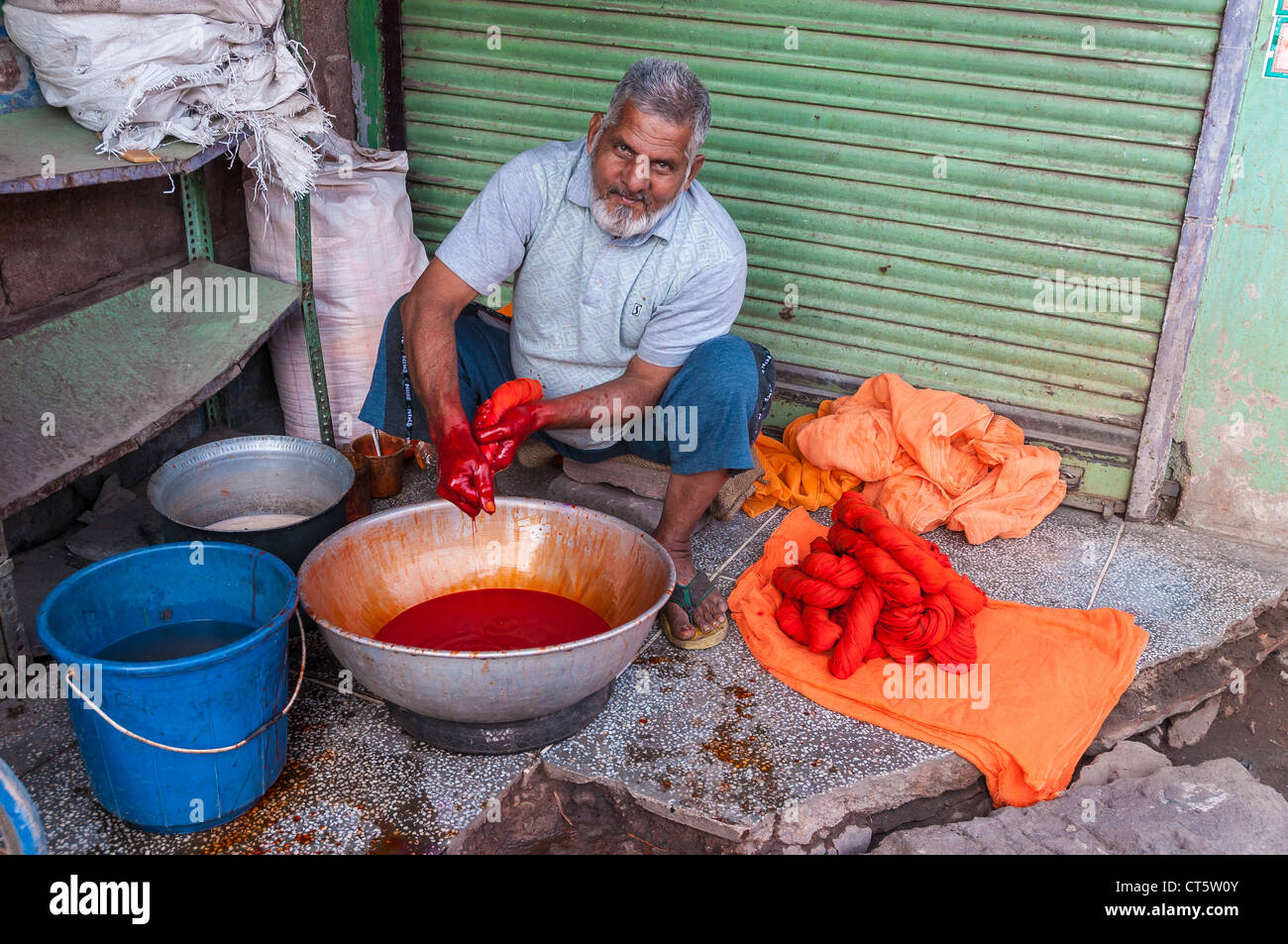 Indian man dyed fabrics in red, Jodhpur, Rajasthan, India Stock Photo