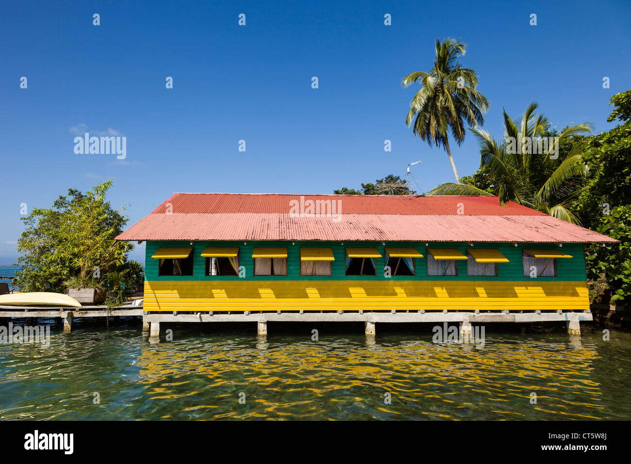 Brightly colored wooden houses sit over the sea in the historic town of Old Bank on Isla Bastimentos, Bocas del Toro, Panama. Stock Photo