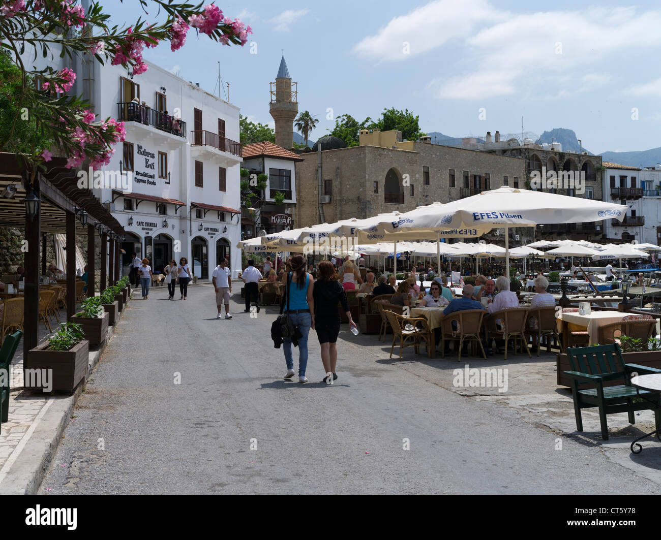dh Girne old Harbour KYRENIA NORTH NORTHERN CYPRUS Tourists strolling restaurant tables on quayside cafe people Stock Photo