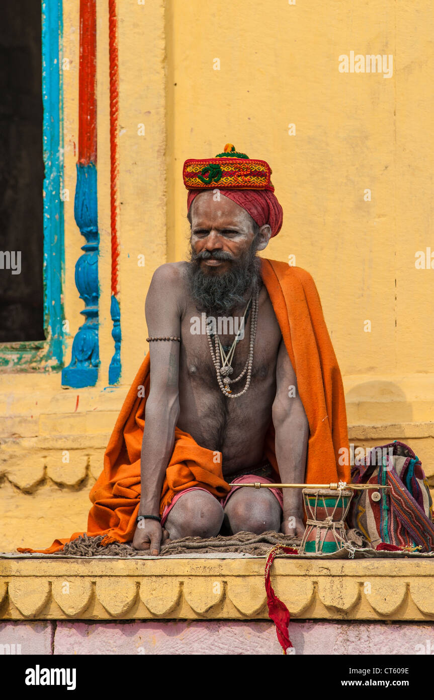 Indian Hindu meditates in front of a temple on the Ganges River, Varanasi, Uttar Pradesh, India Stock Photo