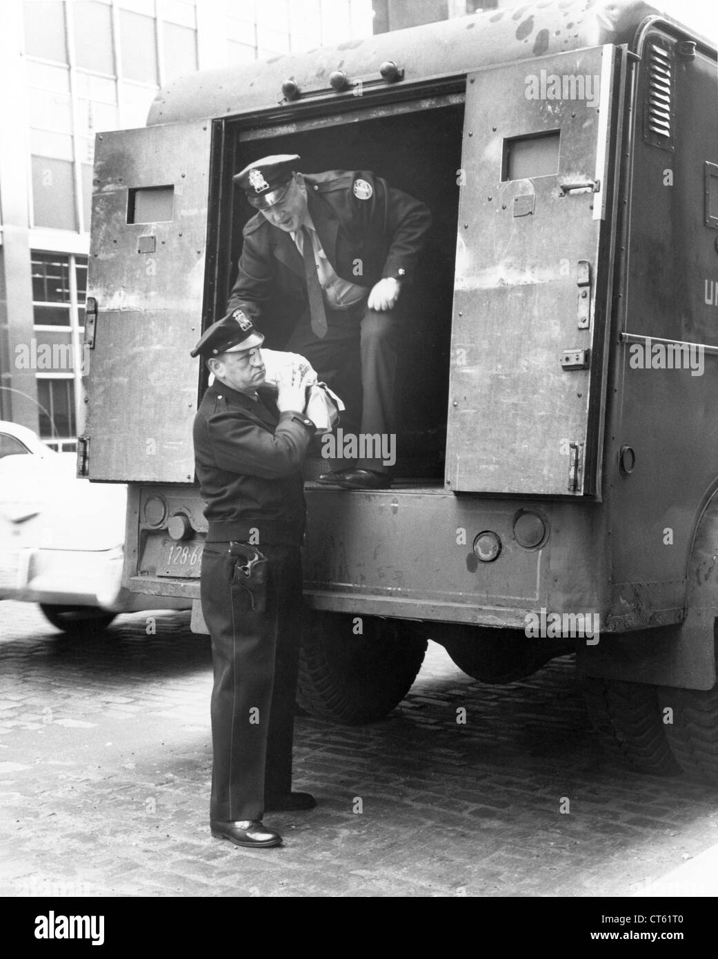 Security guards unloading armored truck Stock Photo