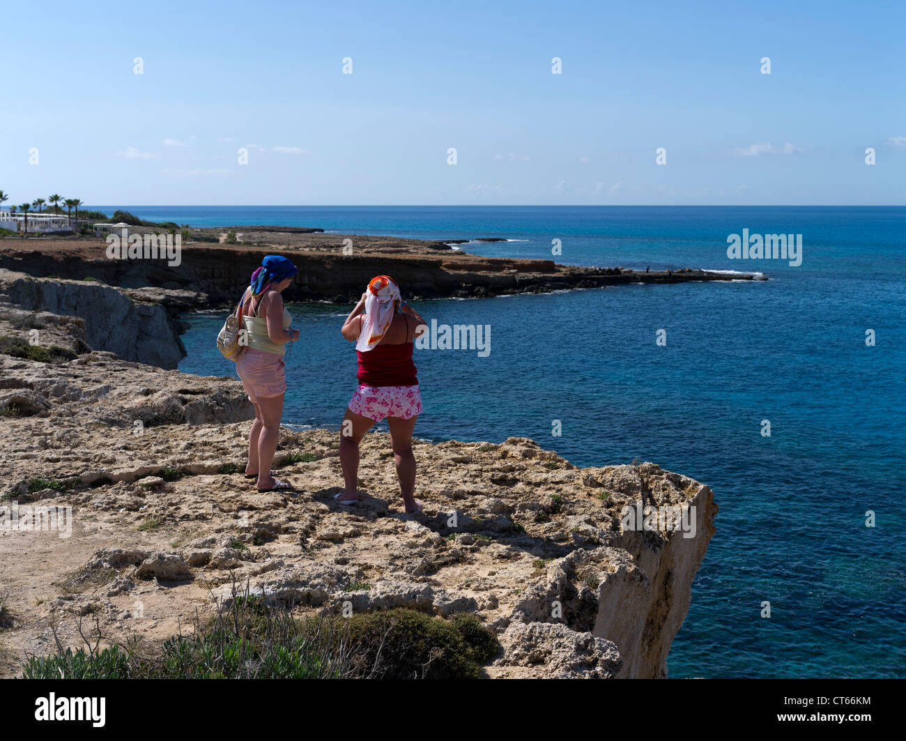 dh Seacliffs AYIA NAPA SOUTH CYPRUS Russian tourists woman on sea cliffs clear blue sea view holiday russians people Stock Photo