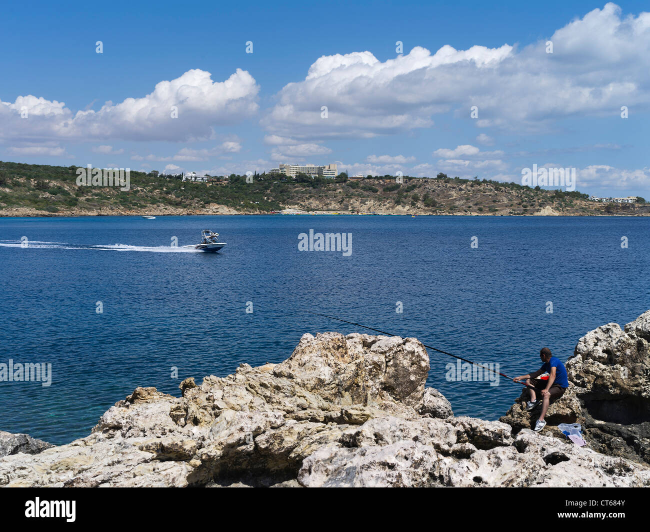 dh Cape greco National Park CAPE GREKO SOUTH CYPRUS Watersport speedboat and man fishing Konnos Bay Agioi Anargyroi people greece angler Stock Photo