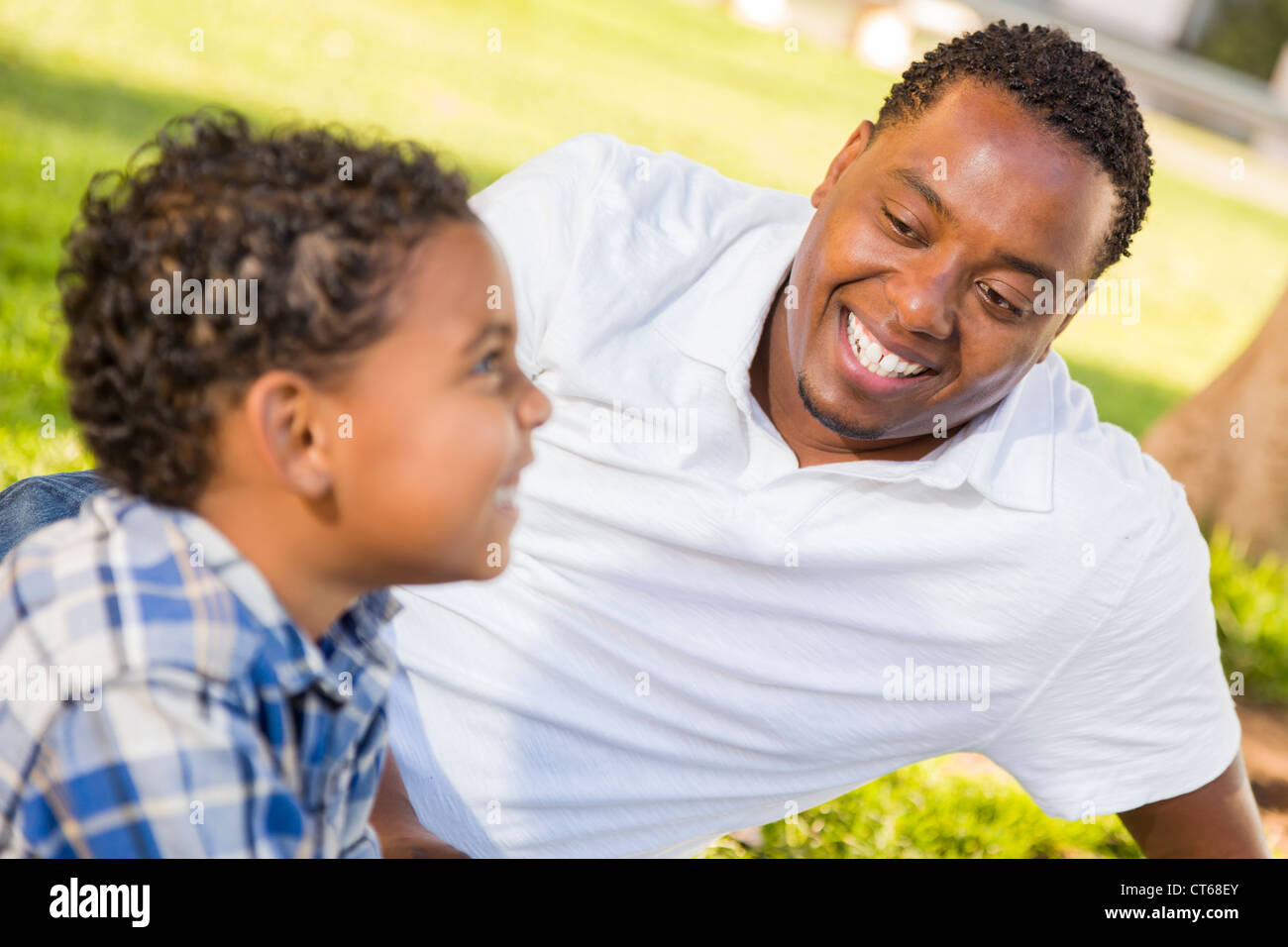 Happy African American Father and Mixed Race Son Playing in the Park ...