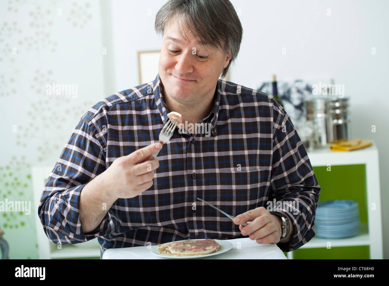 MAN EATING PORK MEAT Stock Photo Alamy