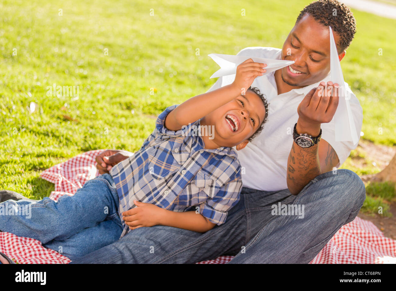 Happy African American Father and Mixed Race Son Playing with Paper ...