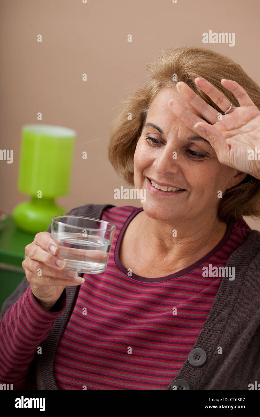 ELDERLY PERSON WITH COLD DRINK Stock Photo