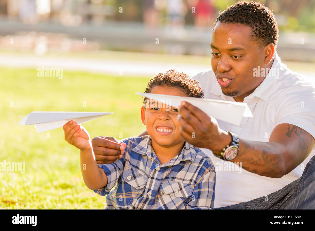 Happy African American Father and Mixed Race Son Playing with Paper ...