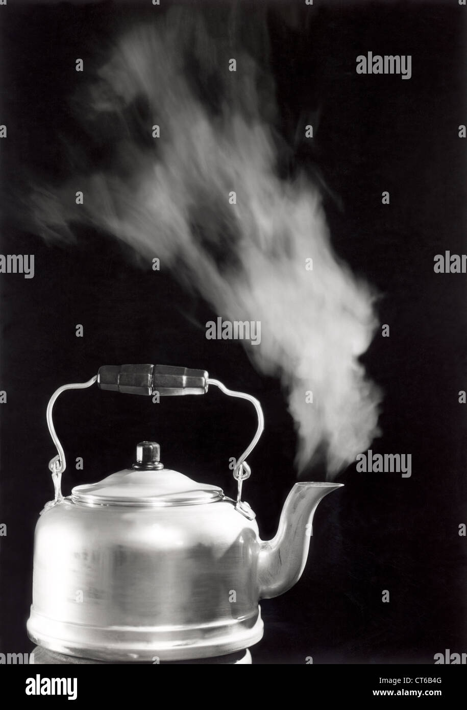 Vintage Teapot boiling with steam Stock Photo