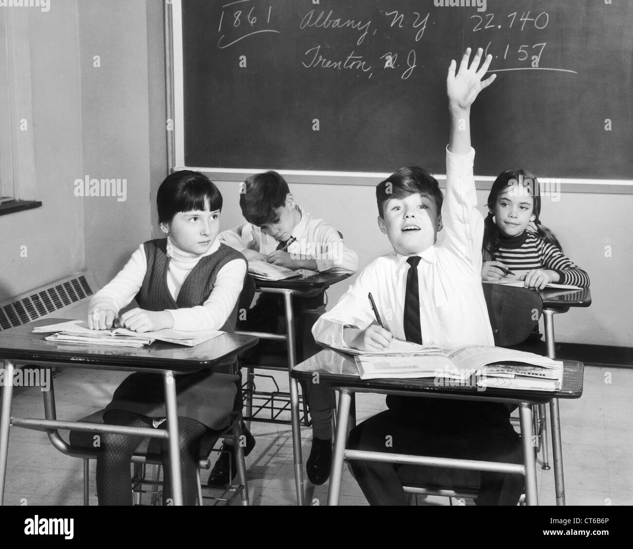 Vintage image of boy raising hand in classroom Stock Photo