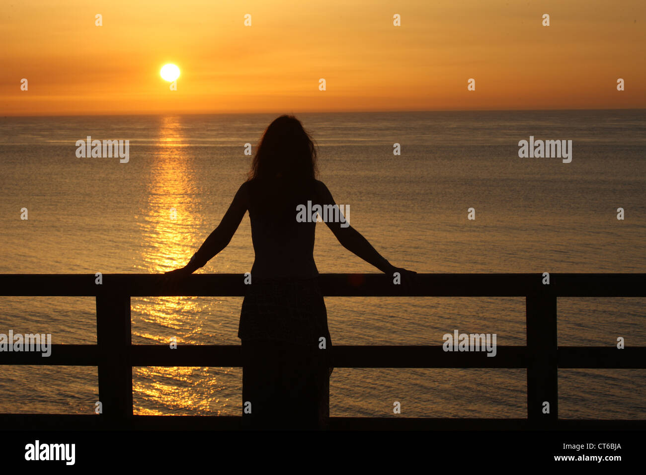 Woman watching a sunset Stock Photo - Alamy