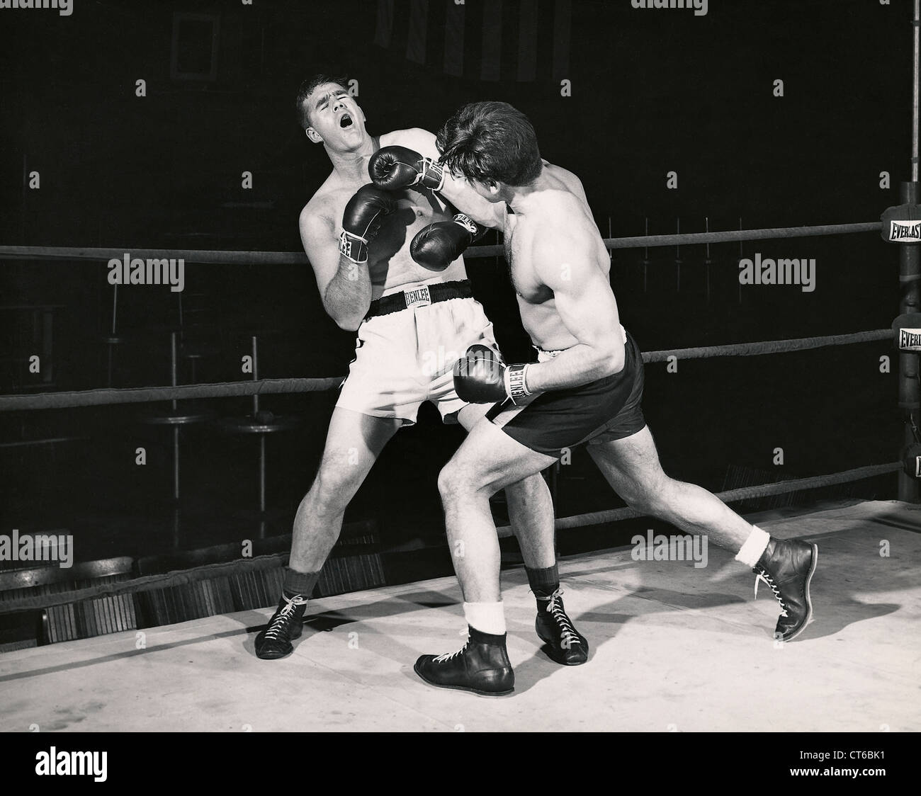 Boxer throws punches at opponent against the rings Stock Photo Alamy