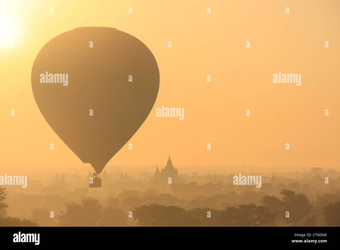 Hot-air ballooning at sunrise, Bagan Archaeological Zone, Mandalay region, Myanmar, Southeast Asia Stock Photo