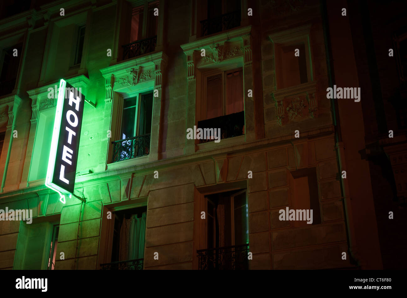 Illuminated green hotel sign on building. Paris, France, Europe. Stock Photo