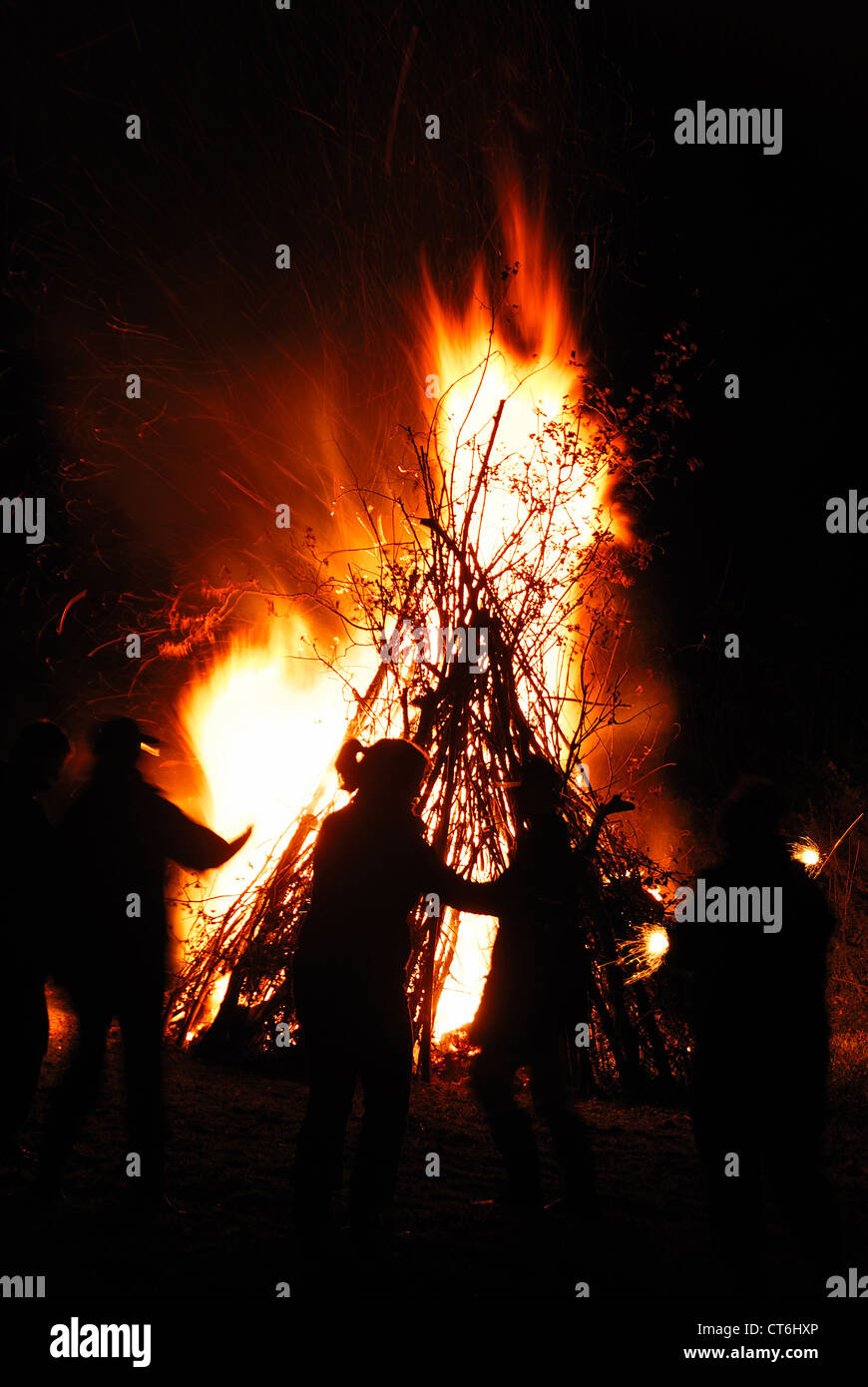 Celebrating November 5th, Guy Fawkes' Night, around a large bonfire UK Stock Photo