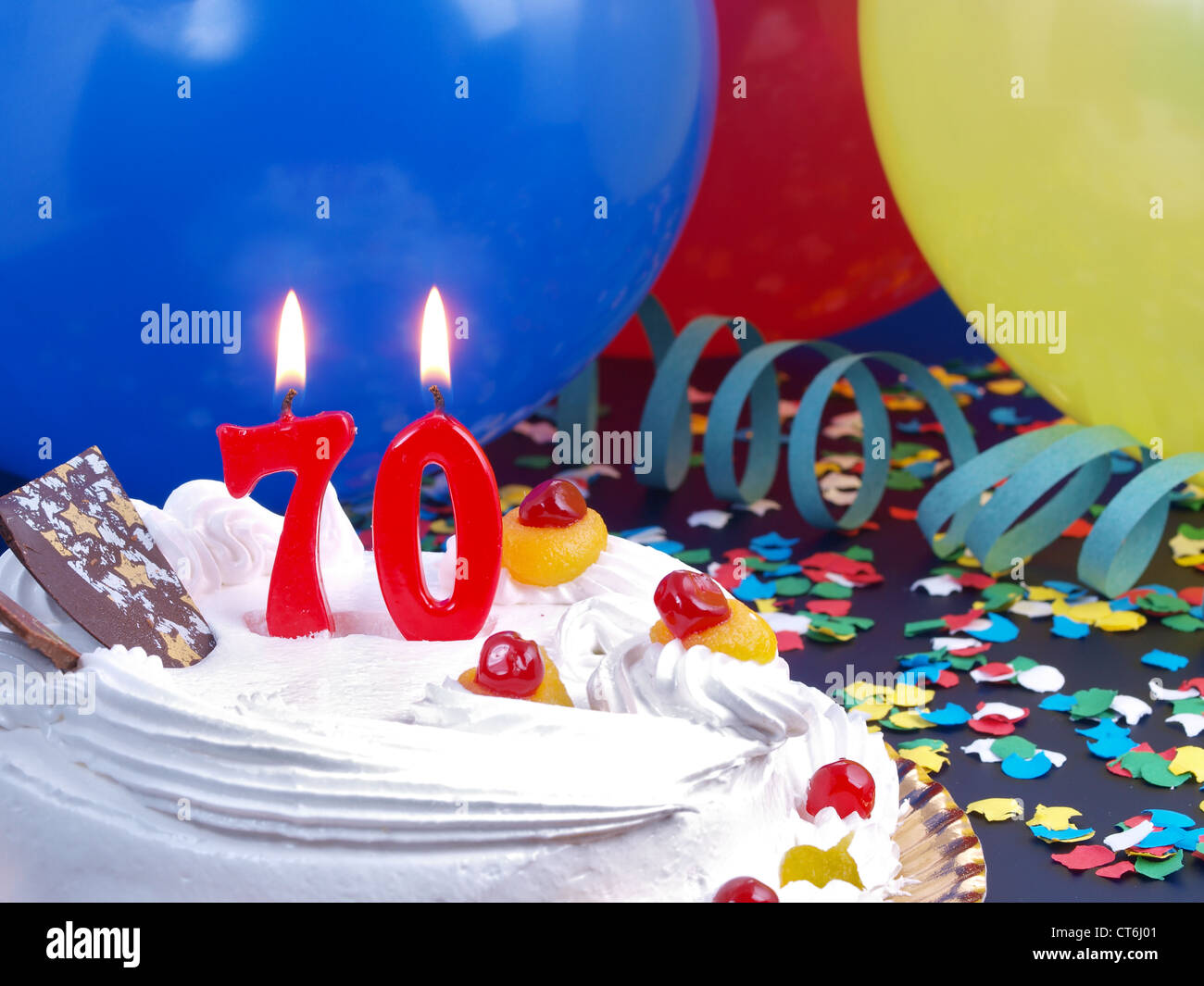 Birthday-anniversary cake with red candle showing Nr. 70 Stock Photo