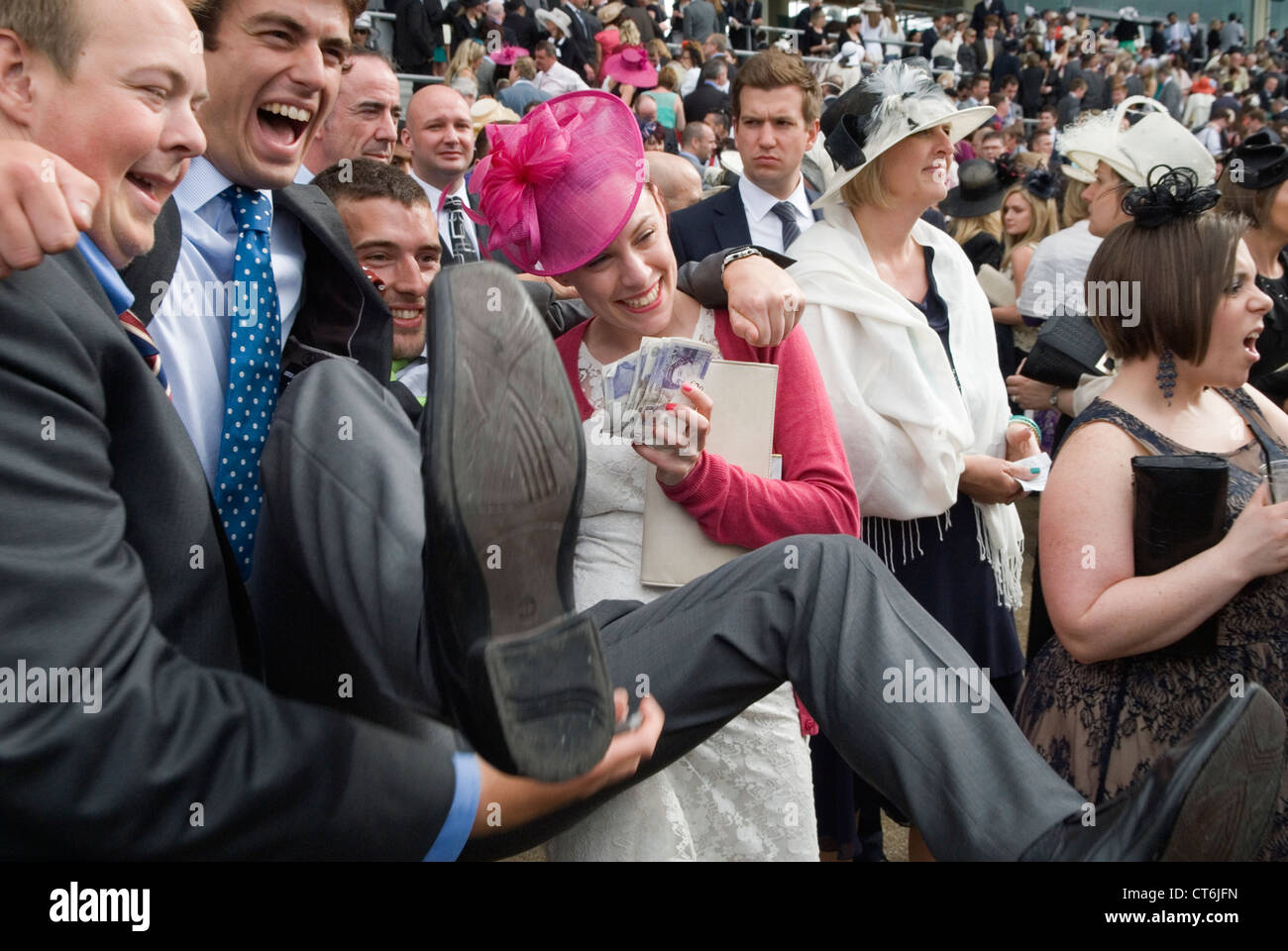 Winning money on the horses, going horse racing. Holding up the winning money. Royal Ascot 2010s
