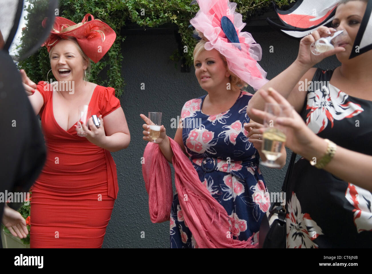 Women UK having fun 2010s Group of girls singing at the bandstand end of the days races Royal Ascot horse racing Berkshire  2012 UK HOMER SYKES Stock Photo