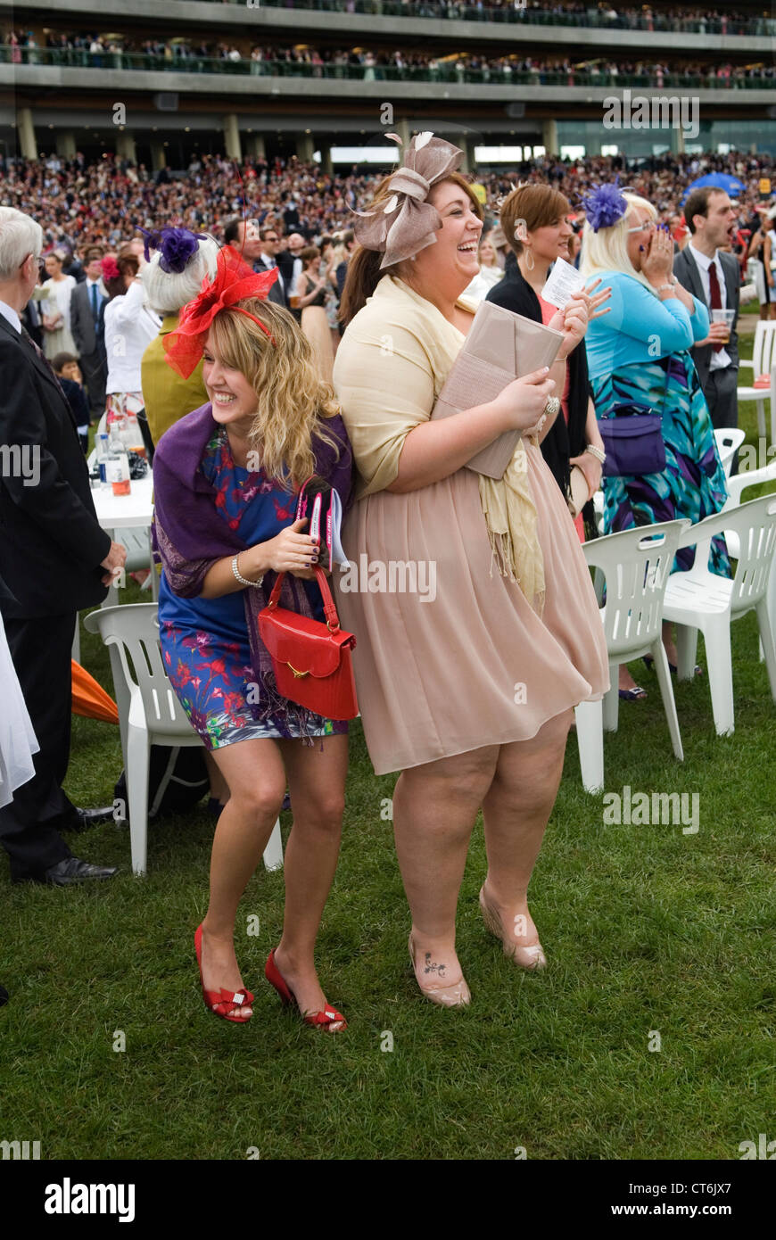 Fat thin women UK contrasting body shape and size Royal Ascot horse racing Berkshire. Two young women, win winning happy, their horse has just won. 2012 2010s HOMER SYKES Stock Photo