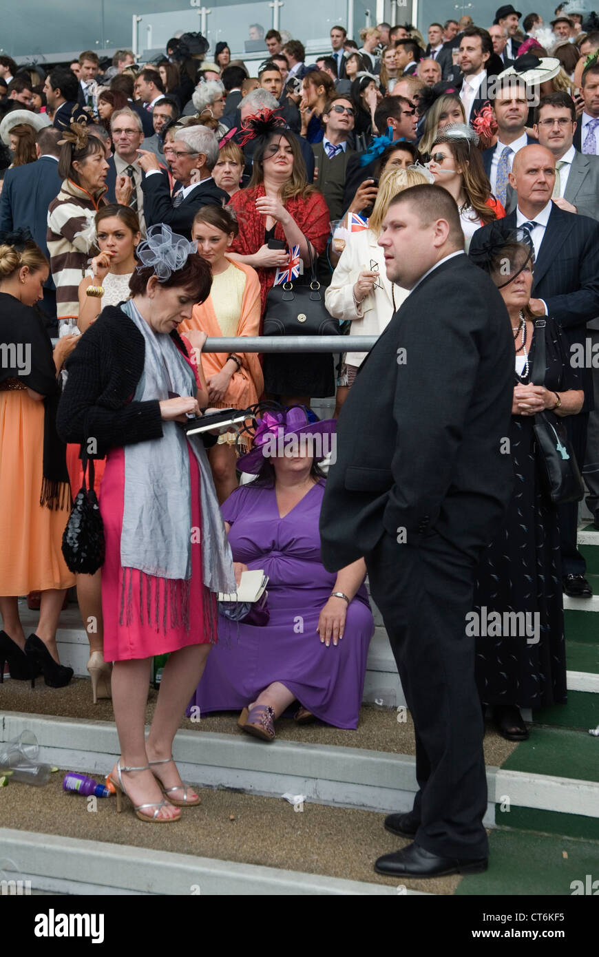 Tired overweight fat woman sitting down exhausted at Royal Ascot horse racing Berkshire. 2012, 2010s UK HOMER SYKES Stock Photo