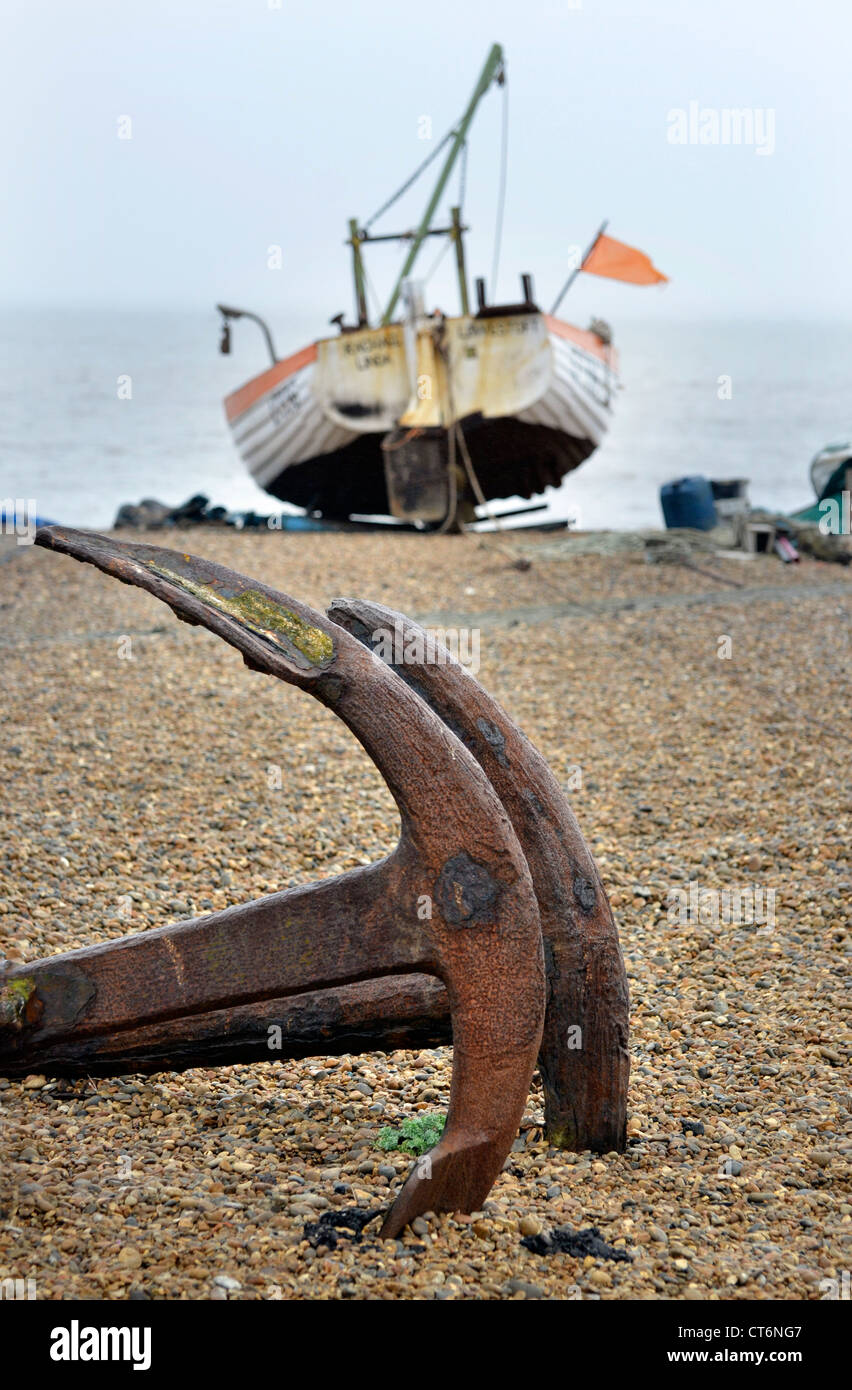 longshore boat and old anchors on beach at aldeburgh suffolk uk Stock Photo