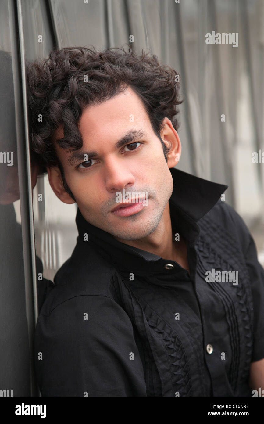 Portrait of a handsome young man posing in black shirt Stock Photo - Alamy