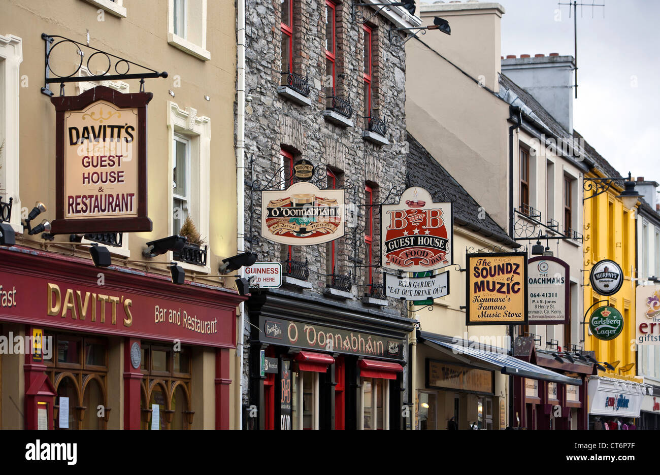 Multicoloured shop fronts with interesting street signs in Kenmare