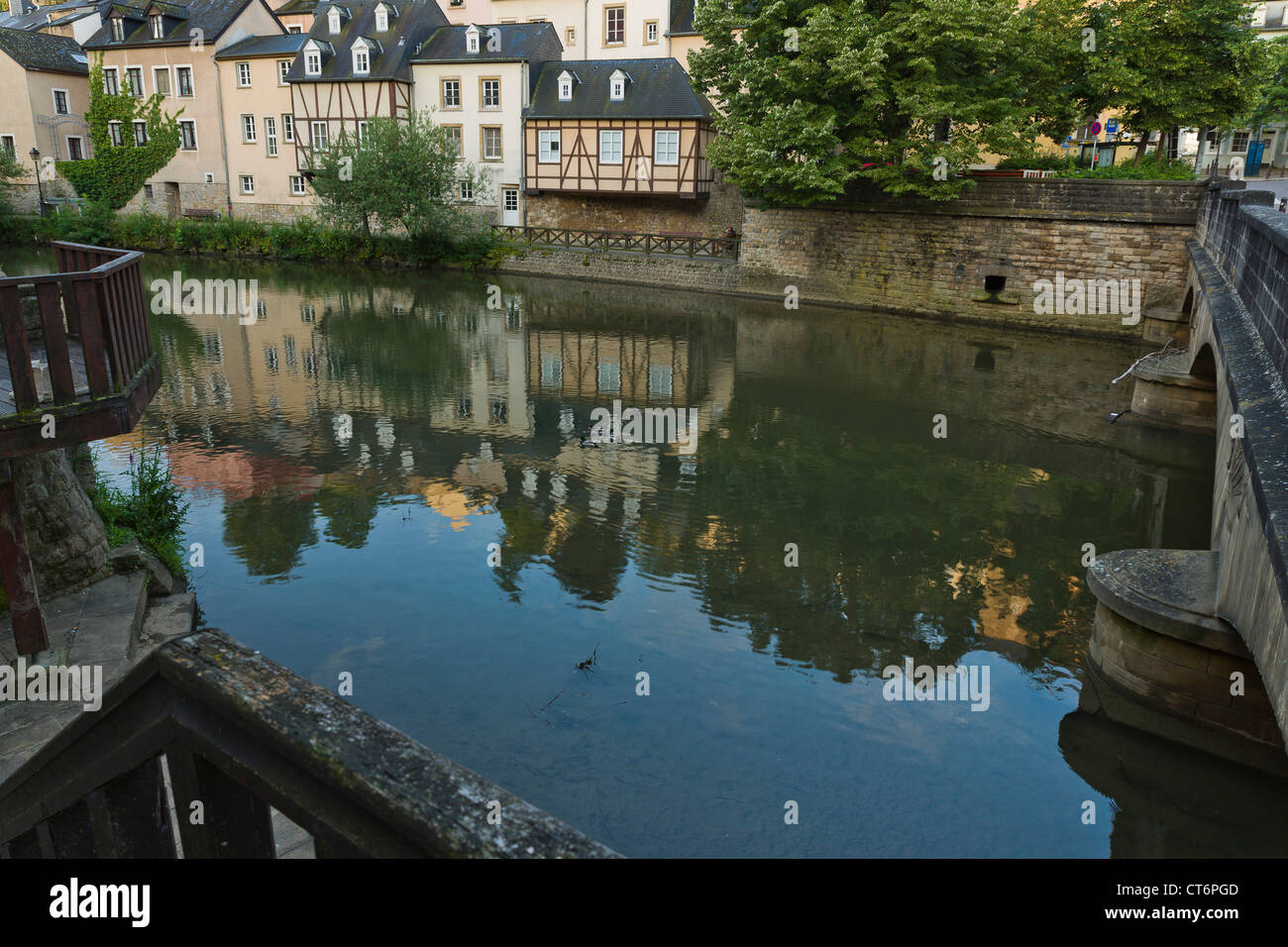 Backside of houses in the rue Saint Ulric in the quarter Grund of Luxembourg City with their Mirror image in the river Alzette. Stock Photo
