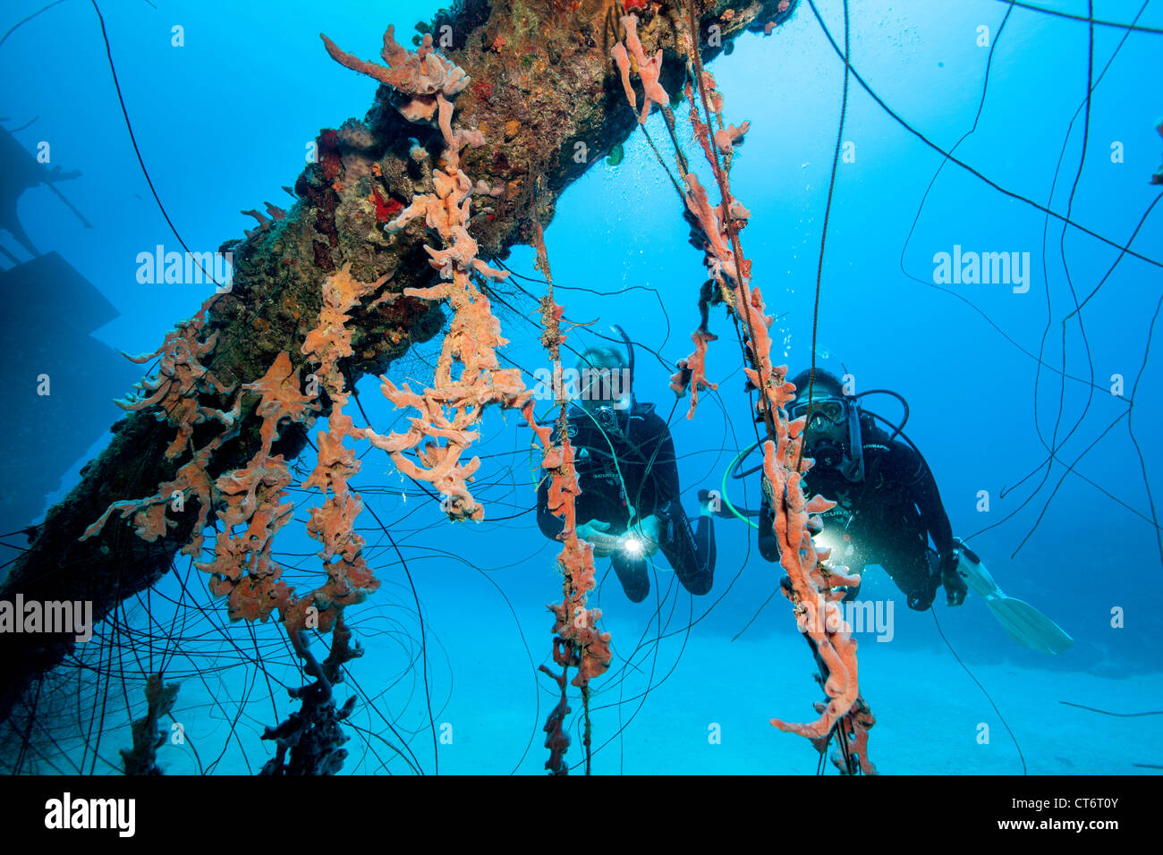 Scuba divers on shipwreck Stock Photo