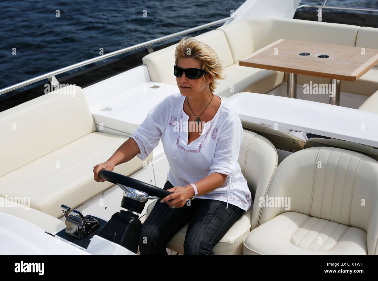 Woman behind wheel of boat hi-res stock photography and images - Alamy