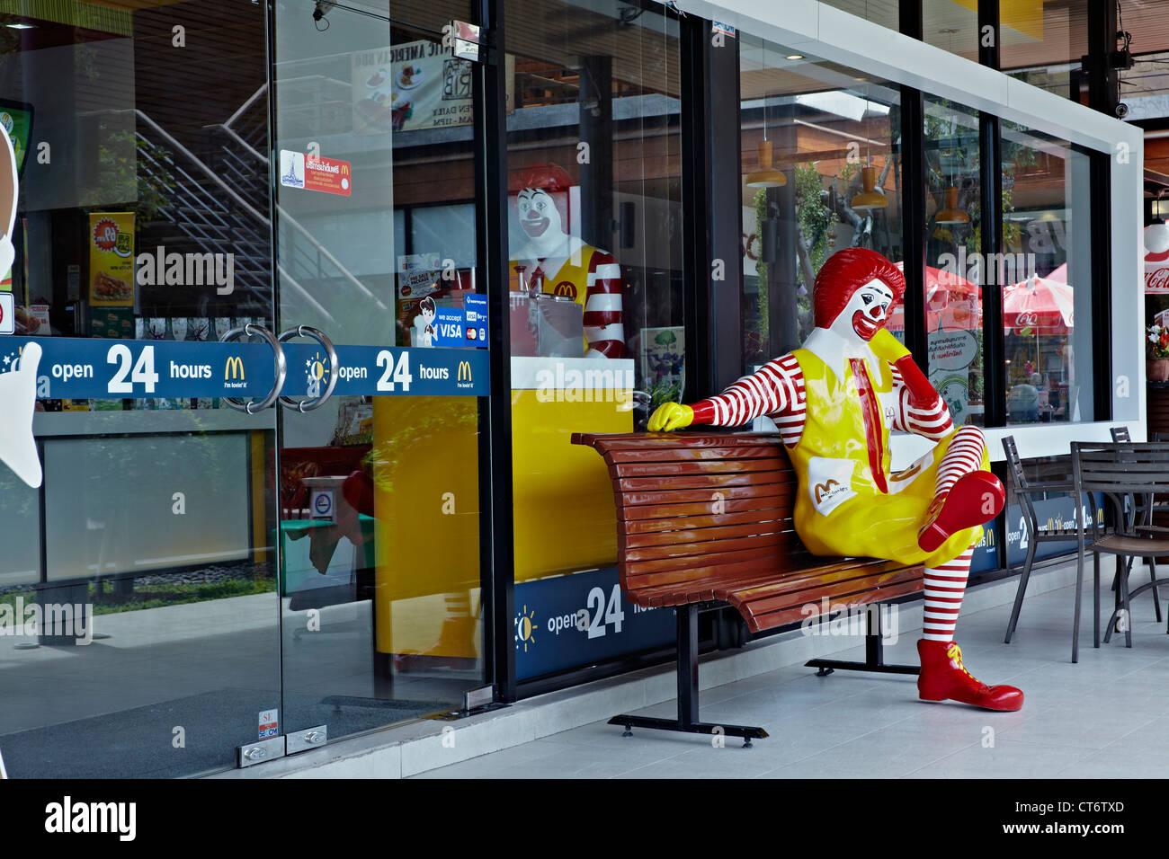 McDonald's restaurant featuring a seated Ronald McDonald figure. Thailand S. E. Asia. Stock Photo