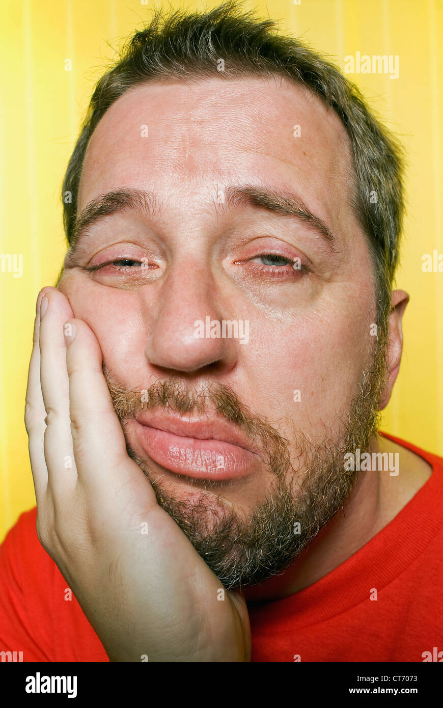A man falling asleep while leaning on his hand. (30's, 40's, thirties, forties.) Stock Photo