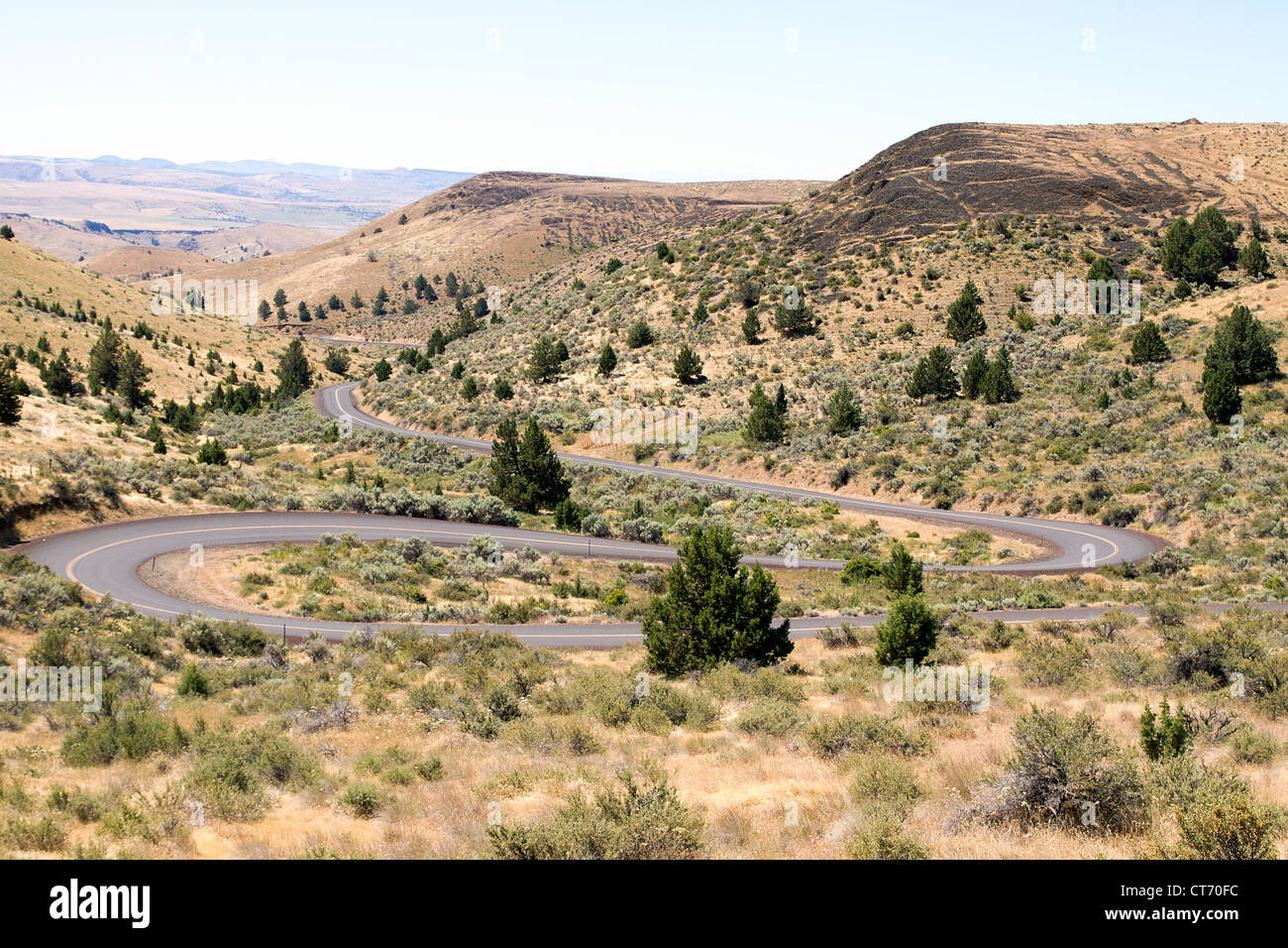Long Winding Highway Along High Desert Farmland Landscape in Central Oregon Stock Photo