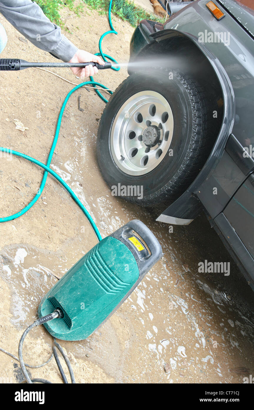 Water spray gun, held by a man, used washing machine Stock Photo Alamy