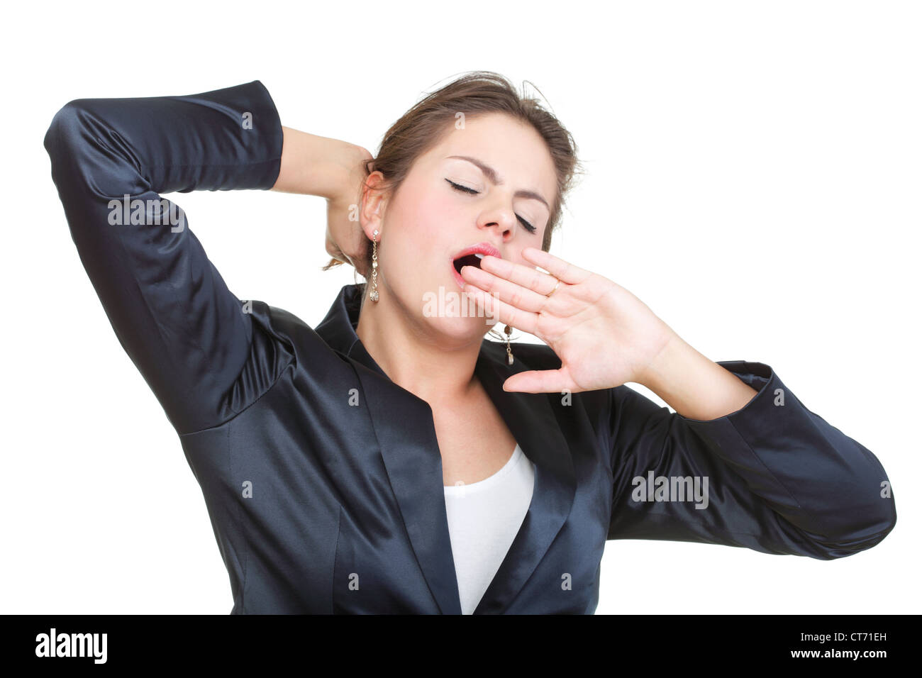 portrait of beautiful tired business woman stretching and yawning at ...