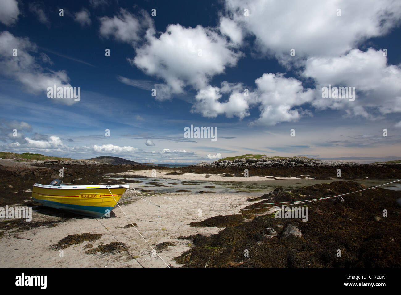 Isle of Barra, Scotland. Picturesque view of a small yellow fishing boat on the east coast of Barra at Earsairidh. Stock Photo