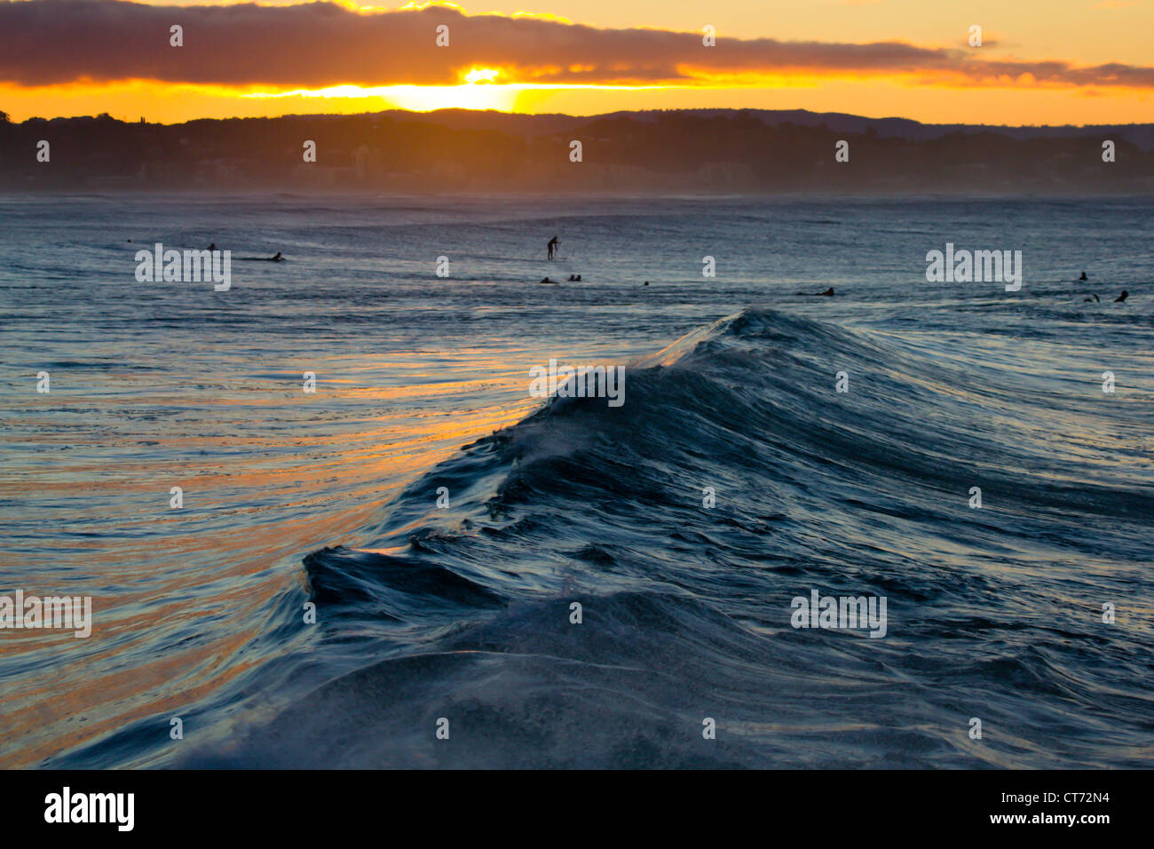 Sunset over ocean surfers hi-res stock photography and images - Alamy