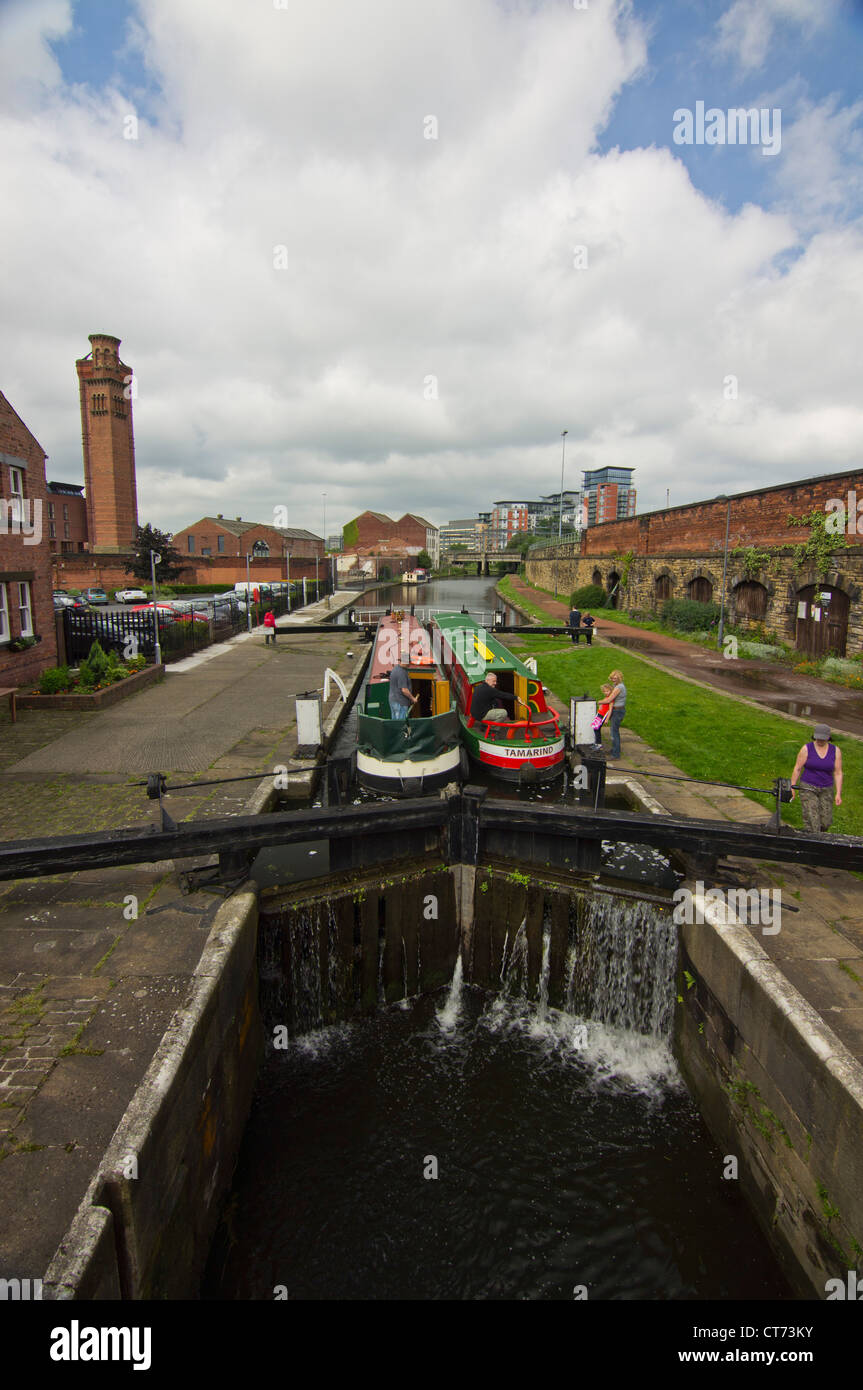 Canal boats going through one of the Locks on the Leeds & Liverpool canal in the center of Leeds Stock Photo