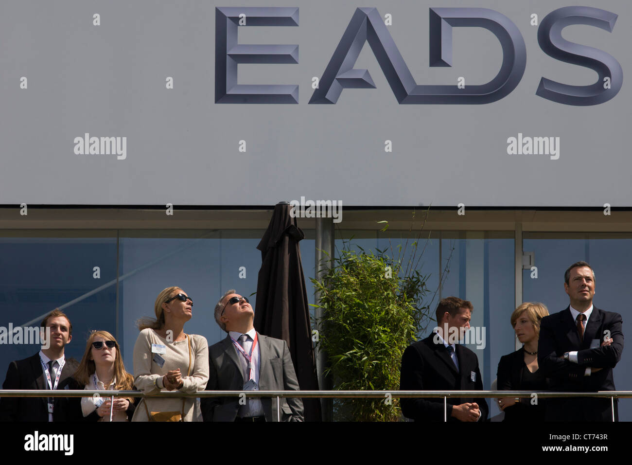 Guests admire aerobatic flying displays outside the EADS hospitality chalet at the Farnborough Air Show Stock Photo